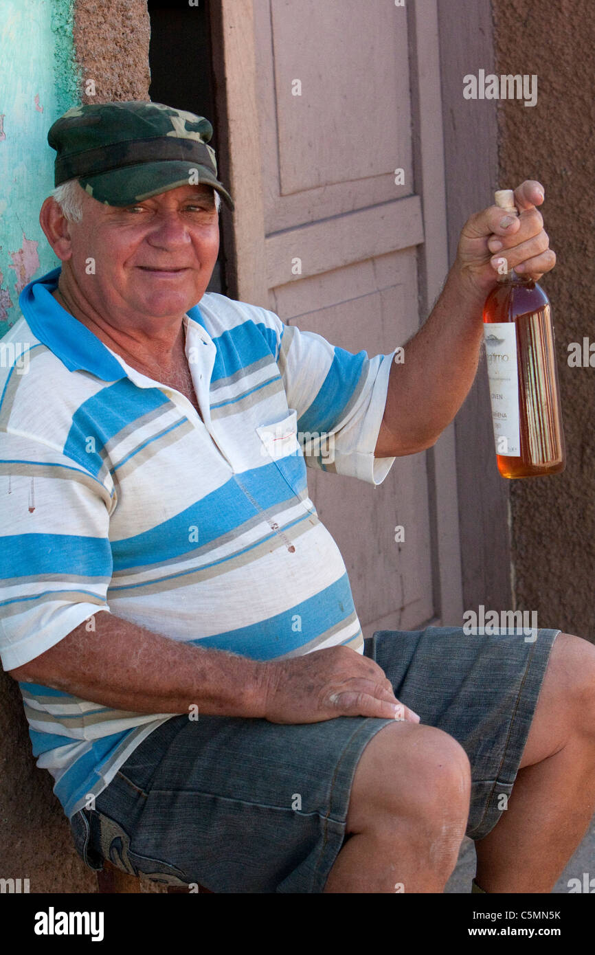 Cuba Trinidad. L'uomo che offre una bottiglia di miele in vendita. Foto Stock