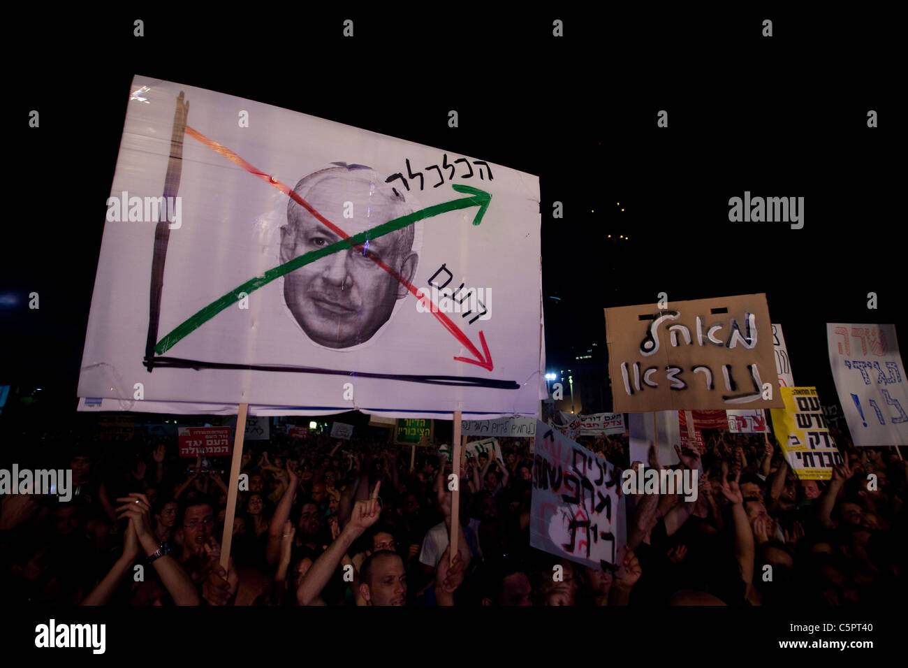 Gli israeliani holding cartelloni come protestano contro il rialzo dei prezzi di alloggiamento e le disuguaglianze sociali di Tel Aviv in Israele. La giustizia sociale protestare anche chiamato tende protesta erano una serie di manifestazioni in Israele a partire dal mese di luglio 2011 coinvolge centinaia di migliaia di manifestanti da una varietà di socio-economica opponendosi al continuo aumento del costo della vita in particolare l'alloggiamento. Foto Stock