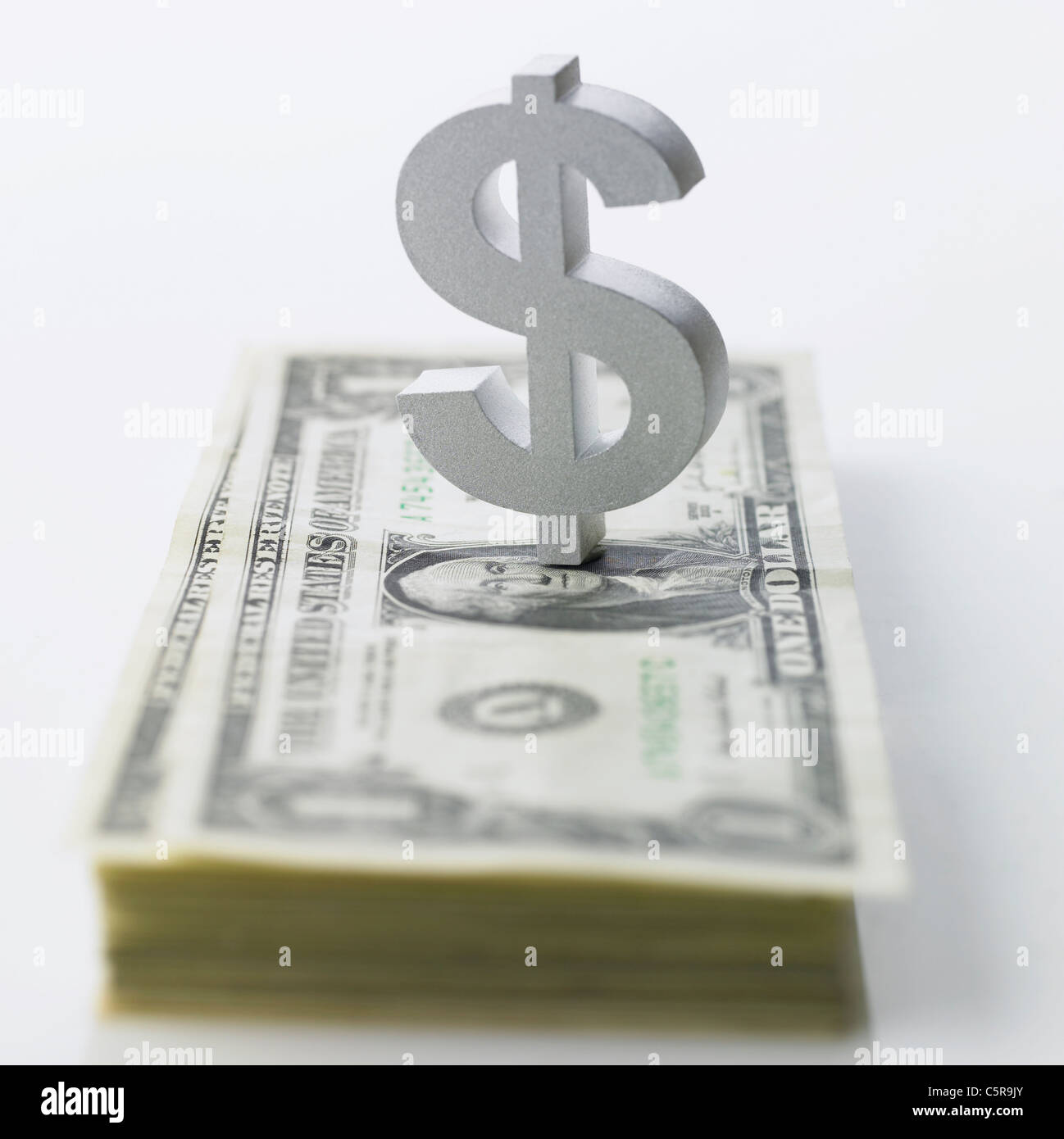Il segno del dollaro e la carta moneta Foto Stock