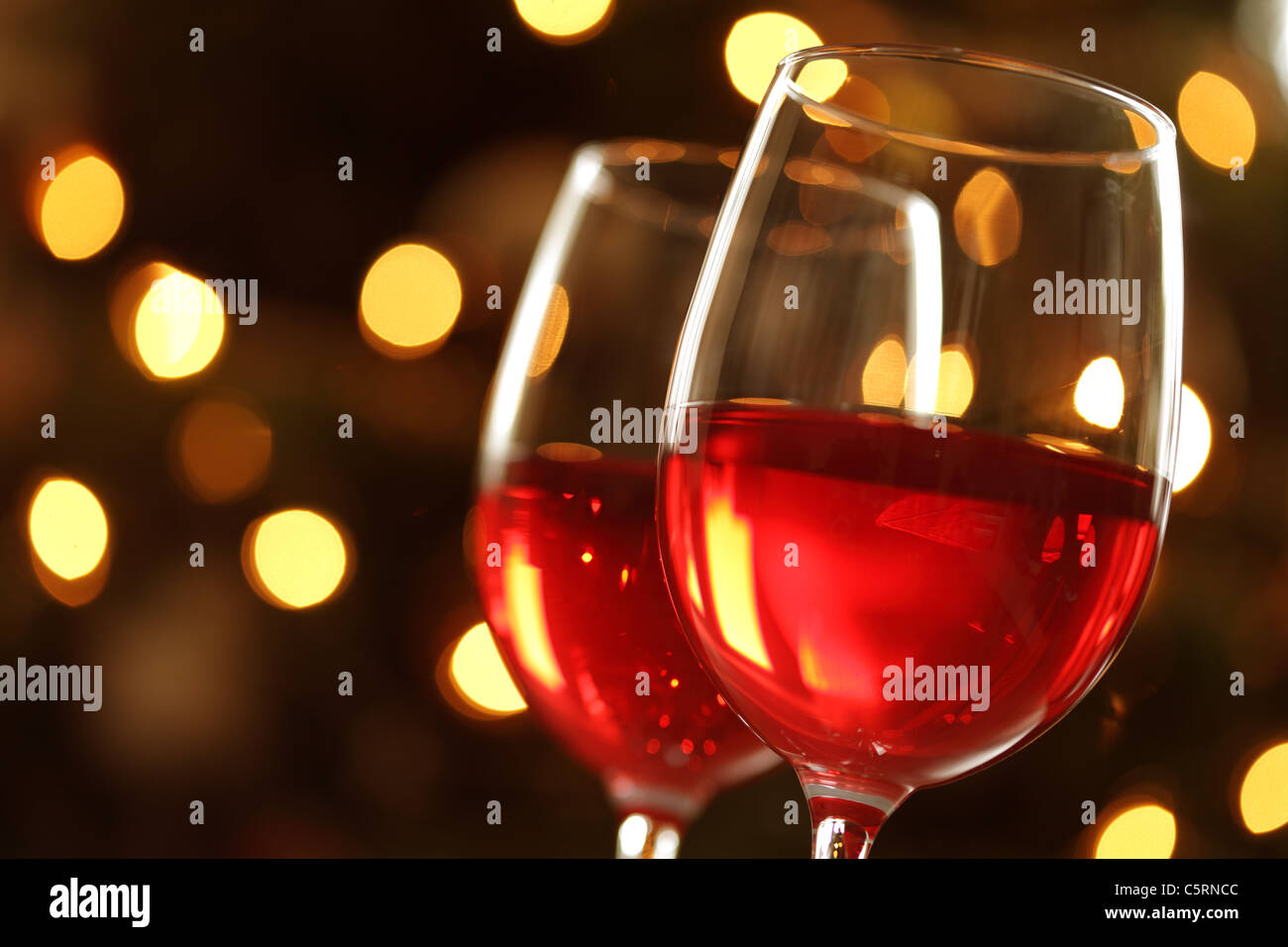 Bicchiere di vino rosso contro le luci defocussed Foto Stock