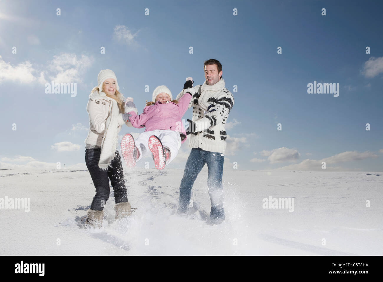 In Germania, in Baviera, Monaco di Baviera, Famiglia con figlia (6-7) nel paesaggio innevato, divertendosi Foto Stock