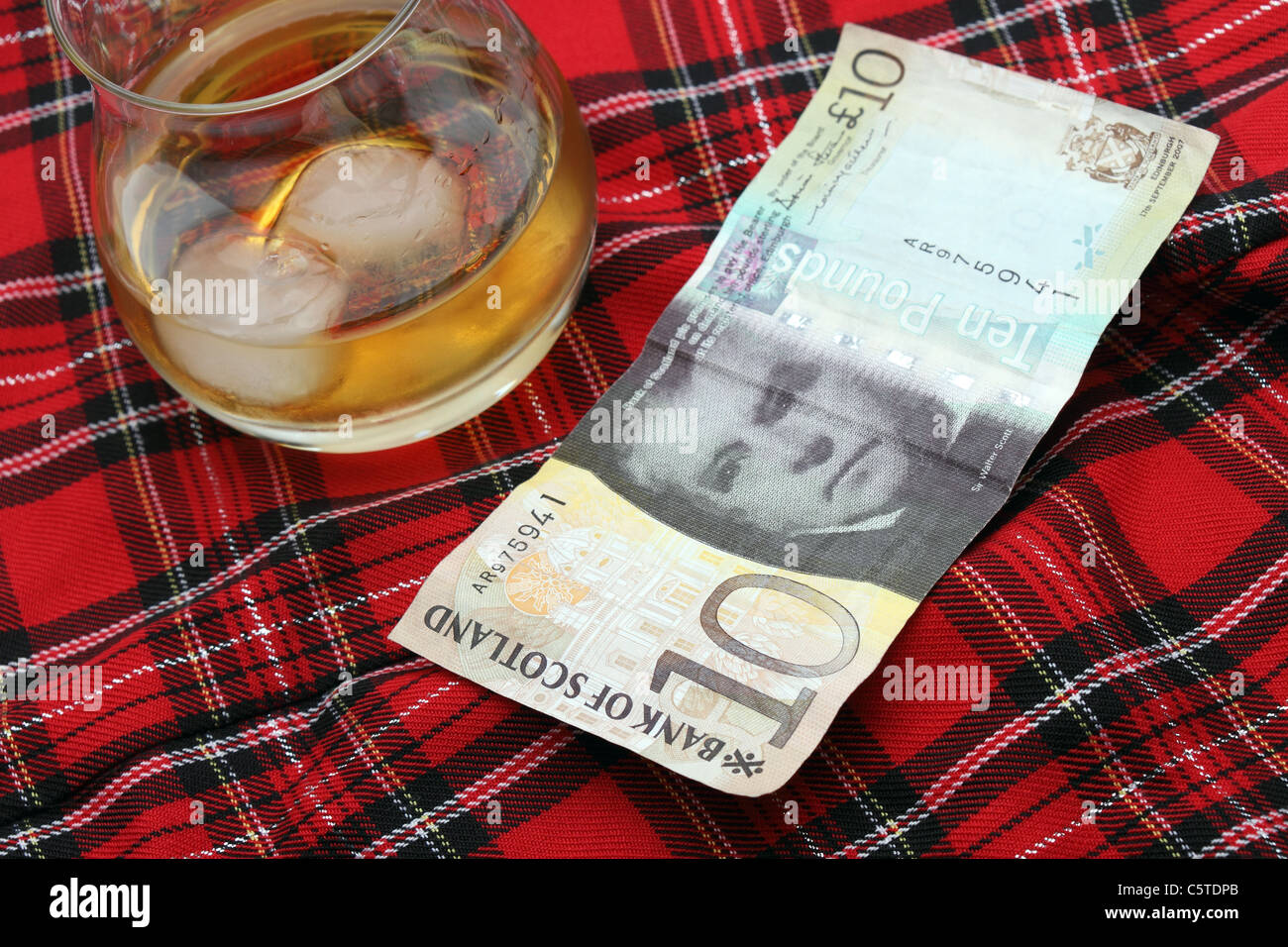 Scottish dieci Pound nota con uno sfondo di tartan e Scotch Foto Stock