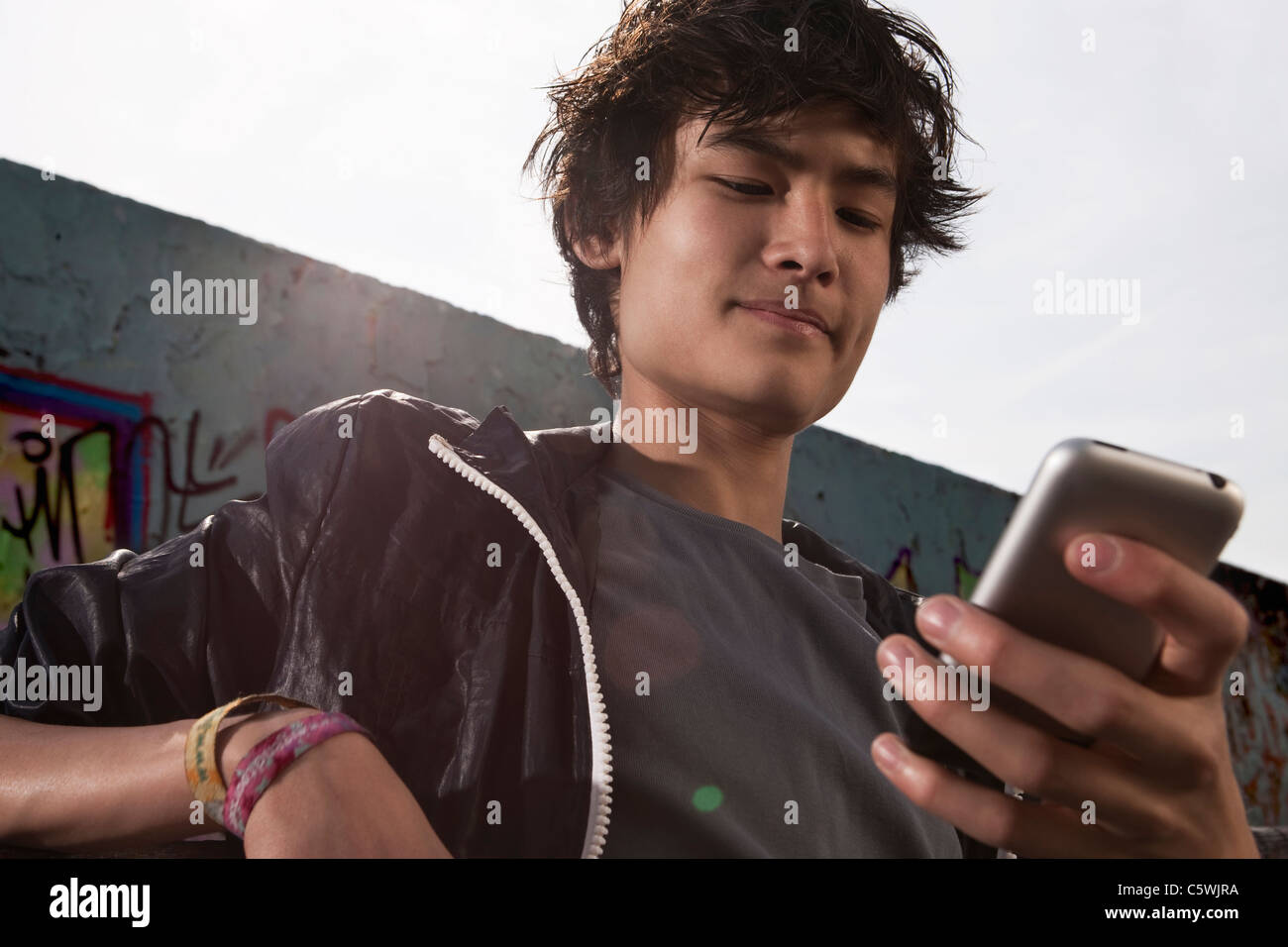 Germania, Berlino, ragazzo adolescente utilizzando il telefono cellulare Foto Stock