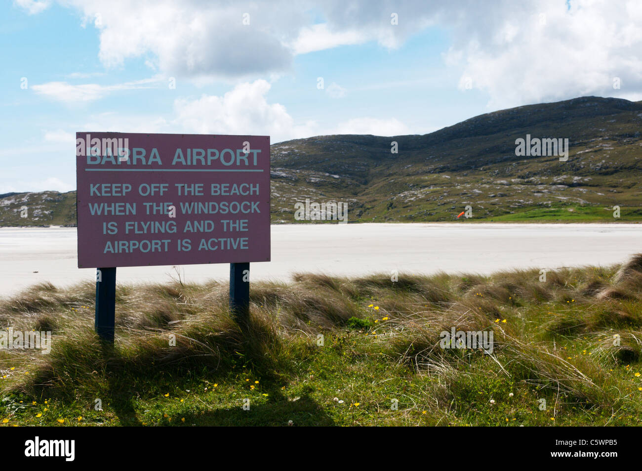 Un segno avverte le persone a tenere spenta la spiaggia di Traigh Mhor nelle Ebridi Esterne quando Barra airport è in funzione Foto Stock