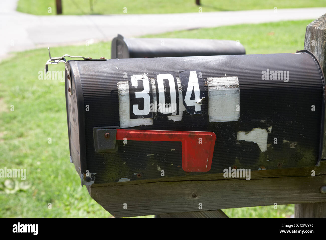 Verniciato di colore nero americano cassetta postale privato con bandiera rossa indicatore in Lynchburg , Tennessee , Stati Uniti Foto Stock