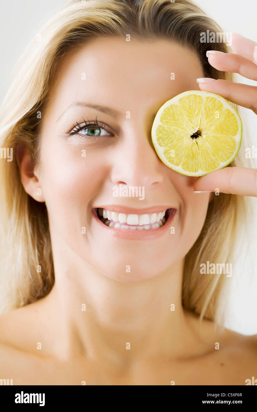 Donna felice con fettina di limone Foto Stock