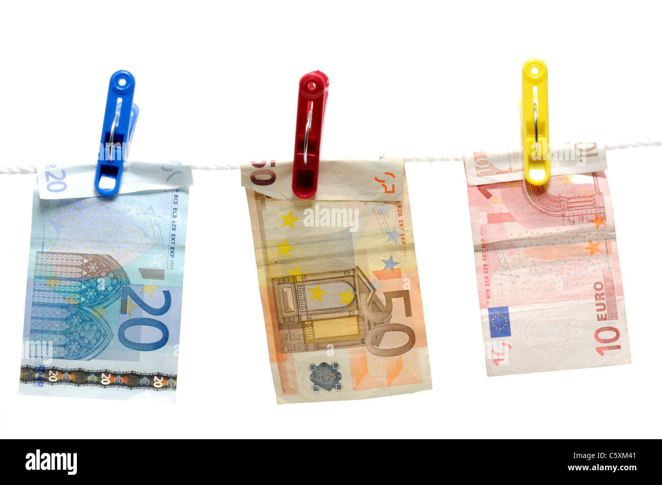 Denaro nel gancio clothespin su bianco Foto Stock