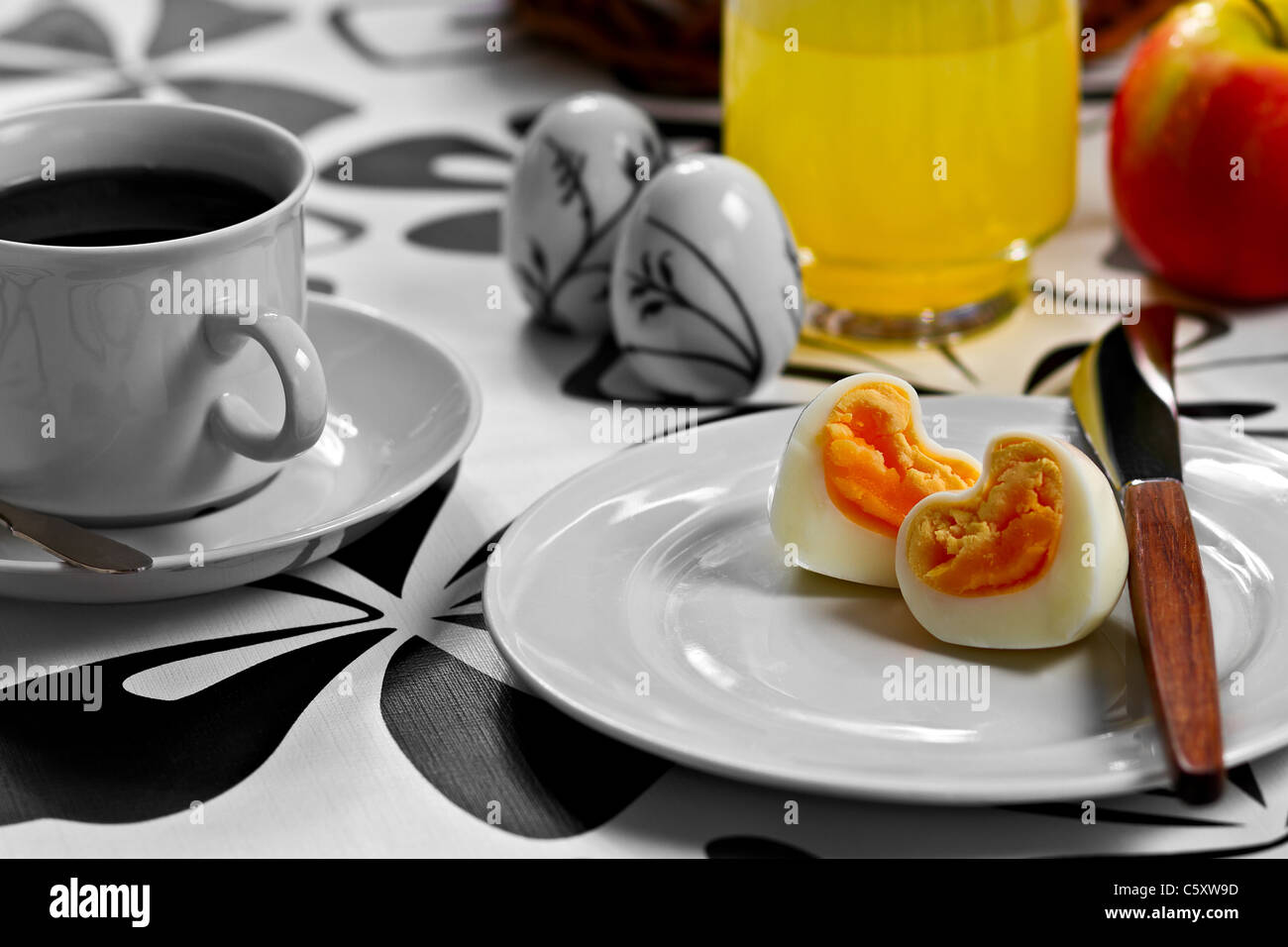 La prima colazione con il cuore a forma di uovo, caffè, succo d'arancia e un apple Foto Stock