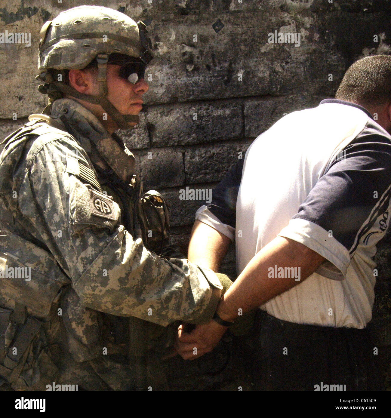 Noi bracciali soldato un iracheno uomo sospettato per la fabbricazione di ordigni esplosivi artigianali durante l'Iraq insurrezione. Mosul Iraq. Il 5 giugno 2007. (BSLOC 2011 12 147) Foto Stock