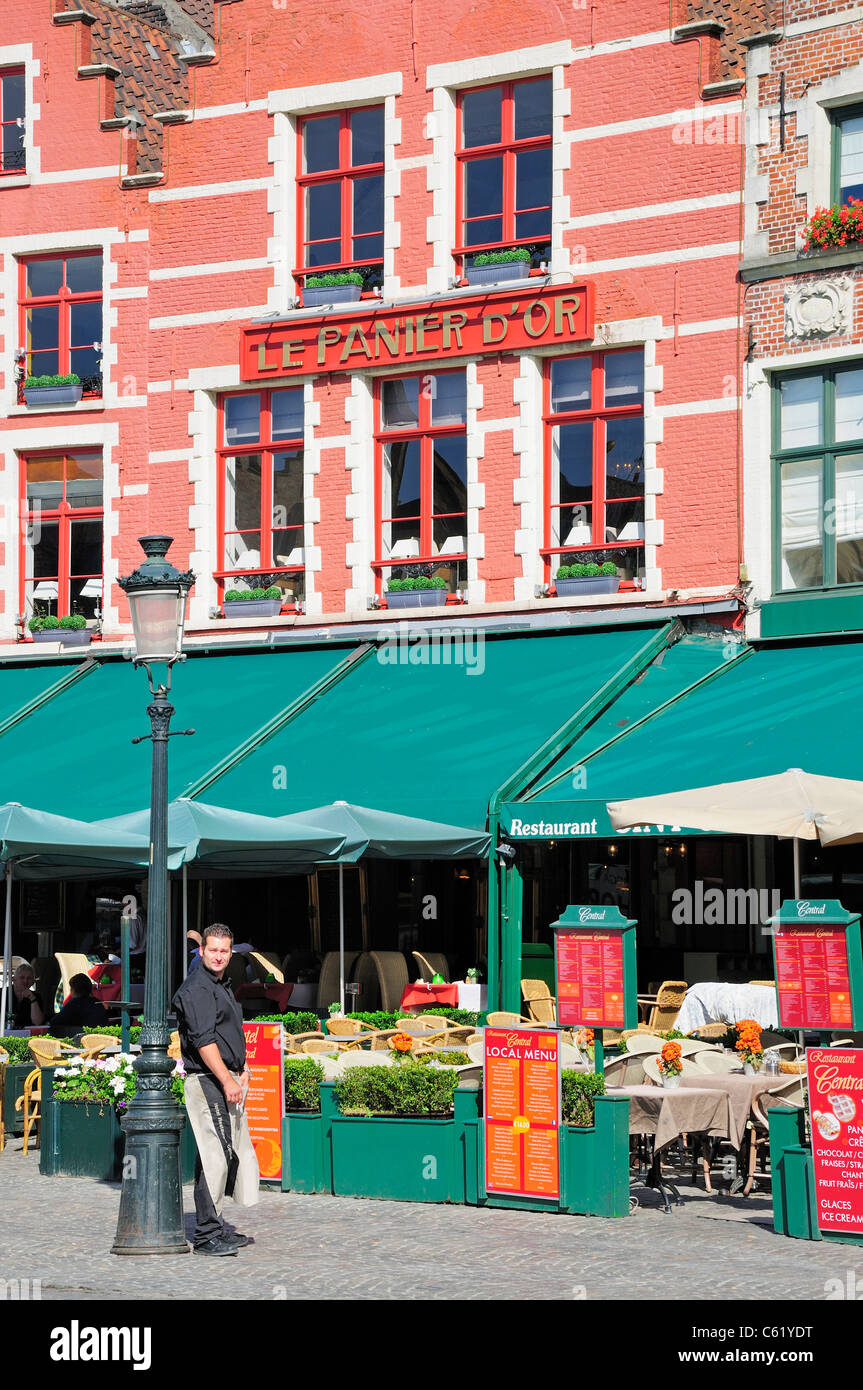 Bruges / Brugge, Fiandre, in Belgio. Markt - piazza principale del mercato. Le Panier D'o un ristorante e il cameriere in attesa Foto Stock