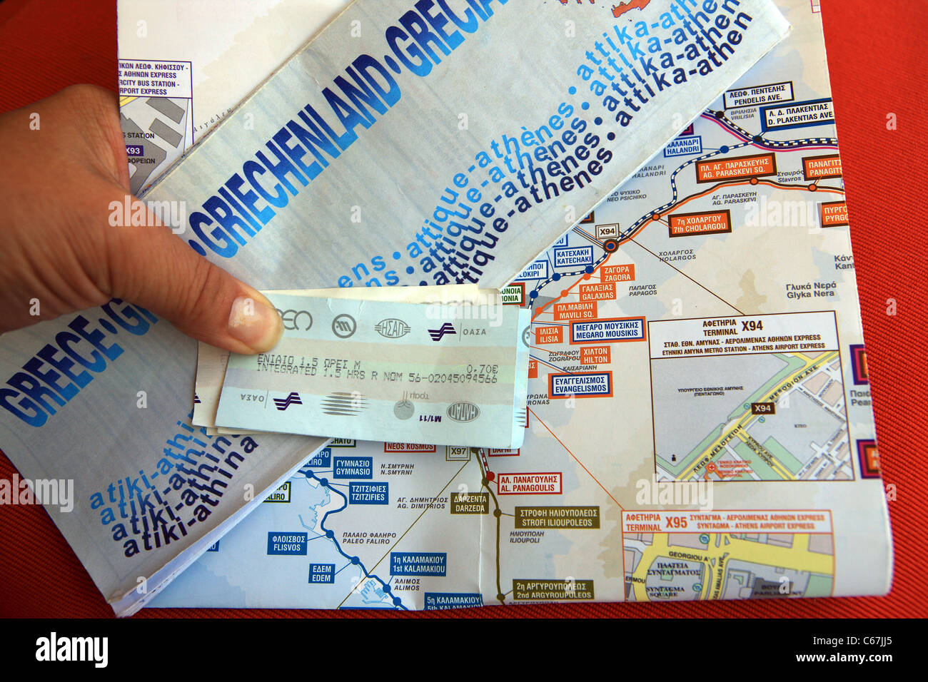 Tourist mano che tiene una mappa di Atene e di biglietti della metropolitana e la mappa Foto Stock