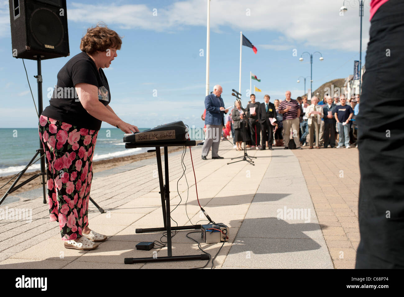 Una donna che gioca l'organo presso un cristiano evangelico all'aperto Servizio di culto sul lungomare a Aberystwyth Wales UK Foto Stock