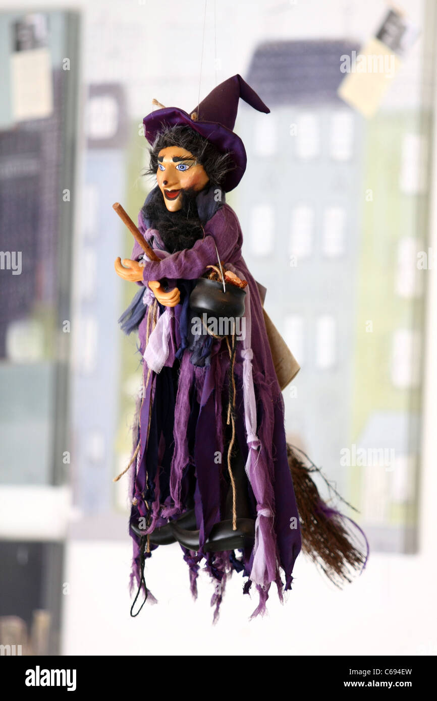 Una strega doll in vendita appesa in un negozio Foto Stock