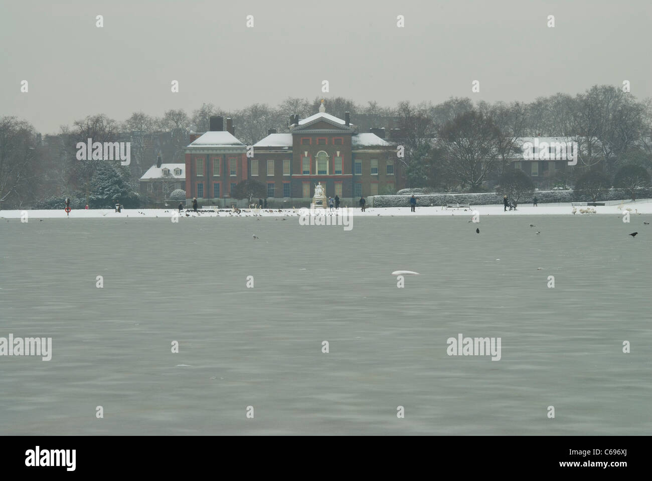Stagno rotondo nell'Hyde Park di Londra guardando verso il Kensington Palace in inverno dopo la nevicata Foto Stock
