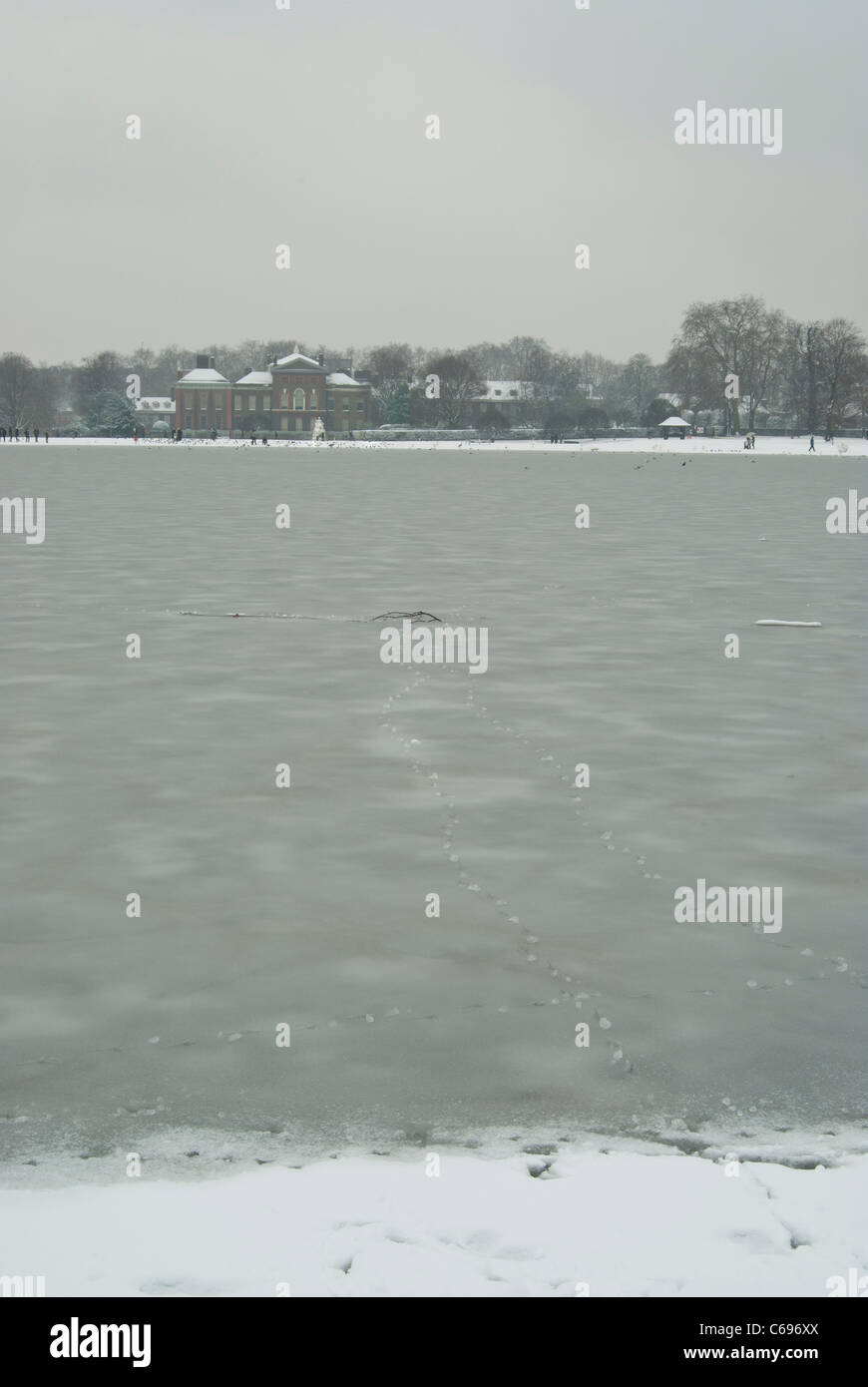 Stagno rotondo nell'Hyde Park di Londra guardando verso il Kensington Palace in inverno dopo la nevicata Foto Stock
