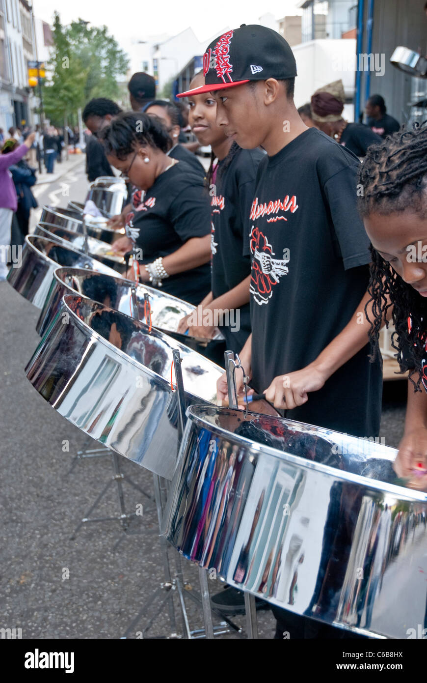 Membro della band da acciaio Metronomes orchestra che suona tamburo di acciaio a Notting Hill Campionati del panorama Foto Stock