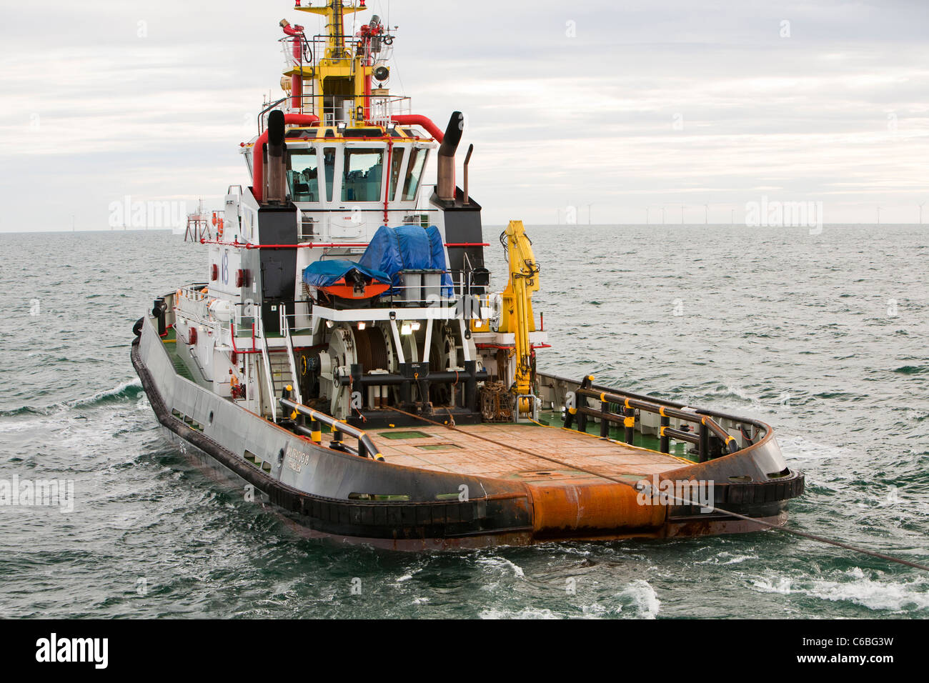 Un rimorchiatore traina il jack up barge il Goliath verso il Walney Offshore wind farm project Foto Stock