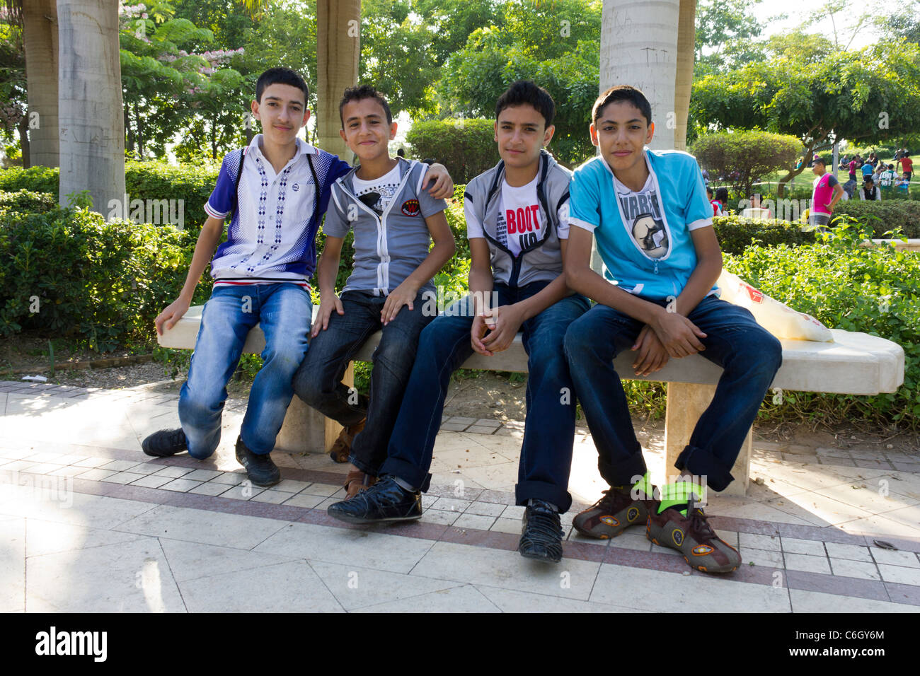 Ragazzi seduta sul banco a al-Azhar Park, celebrazione dell'Eid al-Fitr, che segna la fine del Ramadan, il Cairo, Egitto Foto Stock