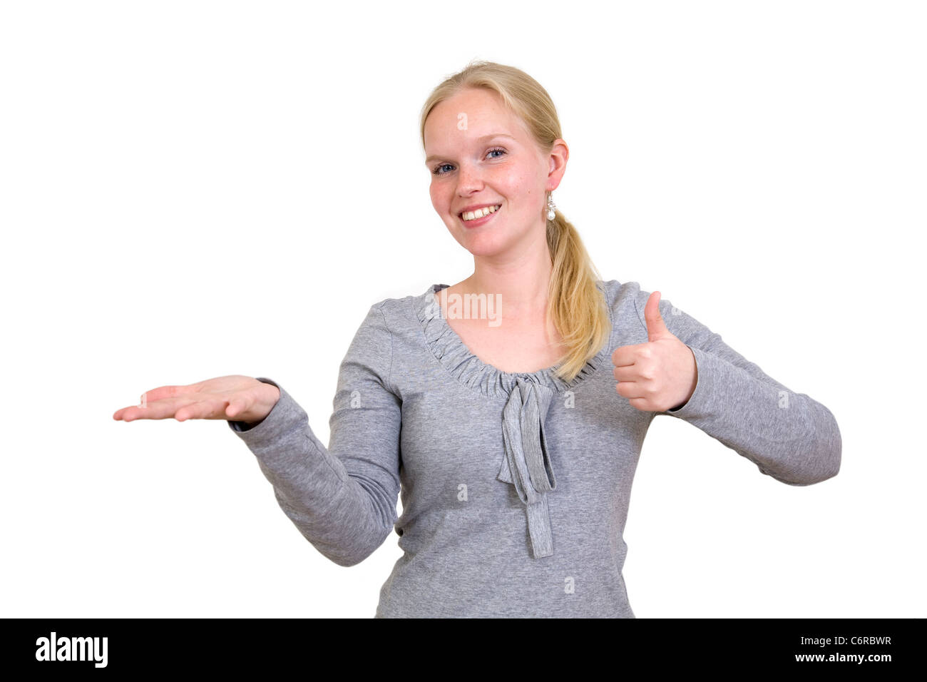 Giovane donna presentare qualcosa Foto Stock