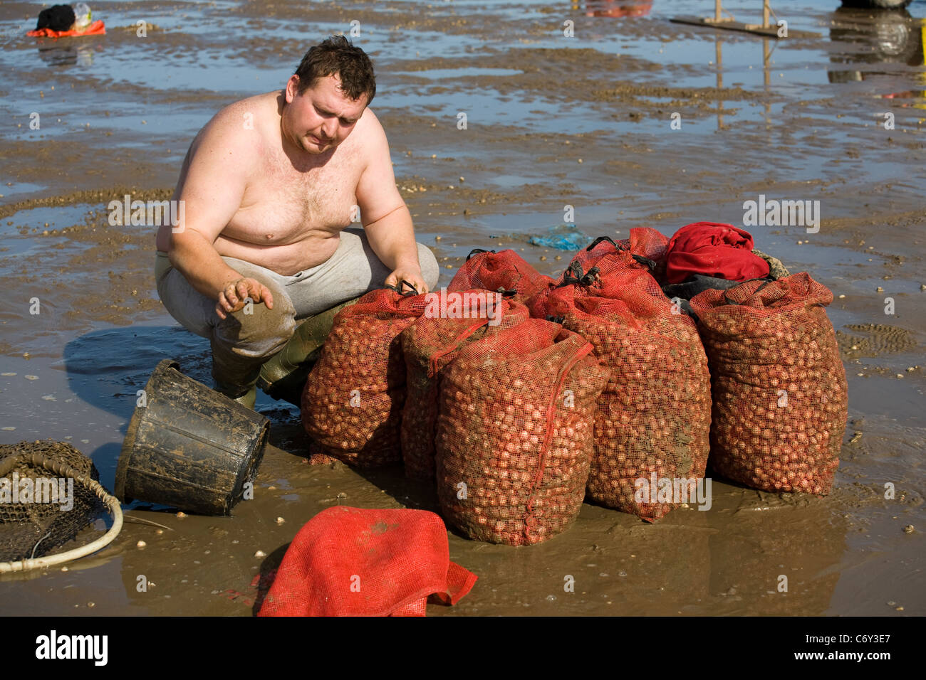 Cocktail in spiaggia con bassa marea su appartamenti di sabbia a Marshside all'inizio della stagione di Cockle picking. Incontro con le mani autorizzato a Southport, Merseyside, Regno Unito Foto Stock