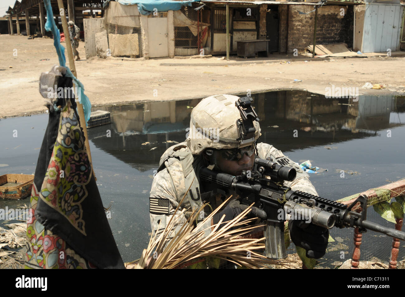 Stati Uniti Army Spc. Marcus Wright dal 3° Brigata truppe speciali battaglione mantiene una posizione di combattimento durante le operazioni nel mercato Jamilla al Sadr City distretto di Baghdad, Iraq, il 15 maggio 2008. DoD foto di Tech. Sgt. Cohen A. Giovani, U.S. Air Force. (Rilasciato) Foto Stock