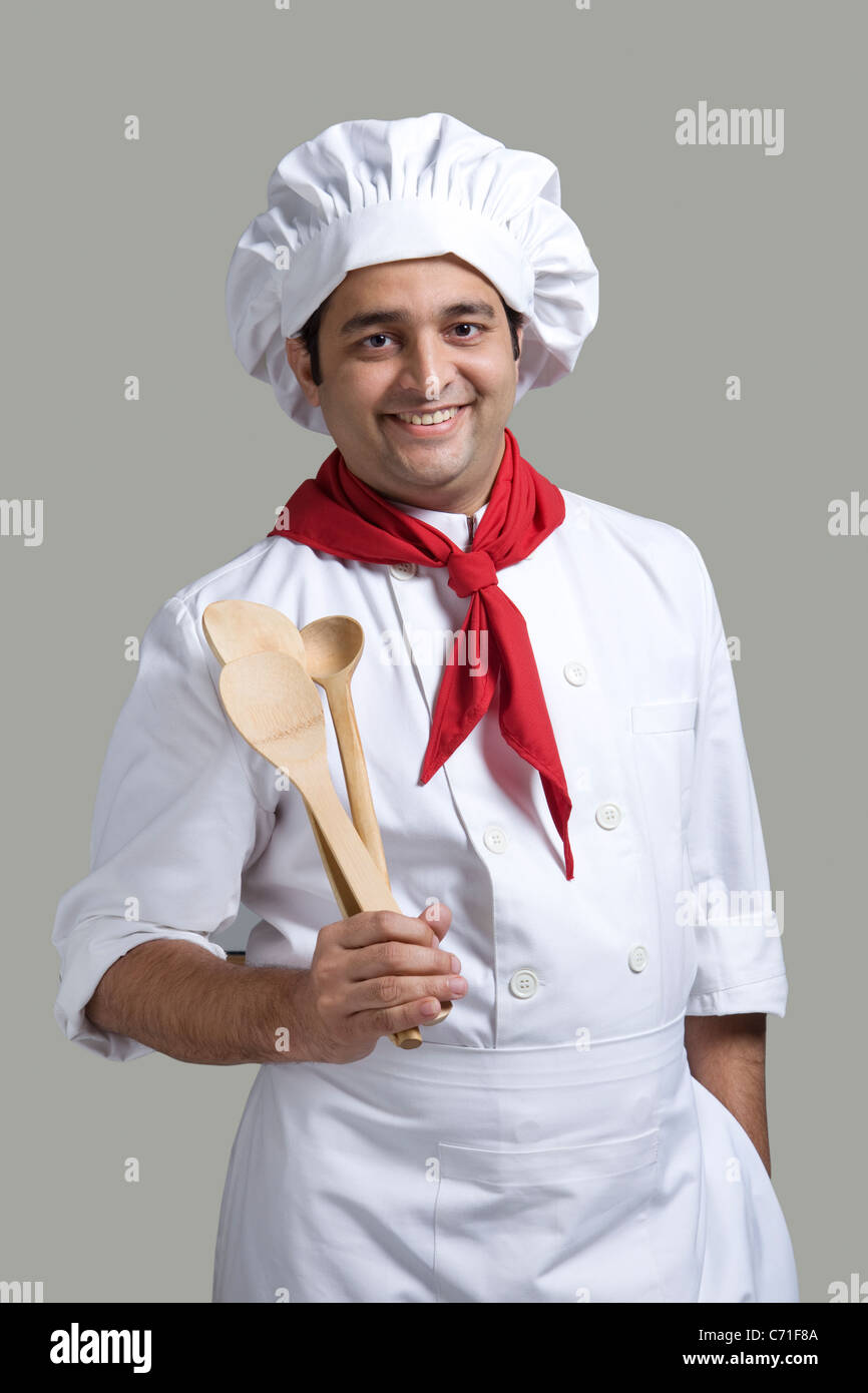 Ritratto di uno chef con cucchiai di legno Foto Stock