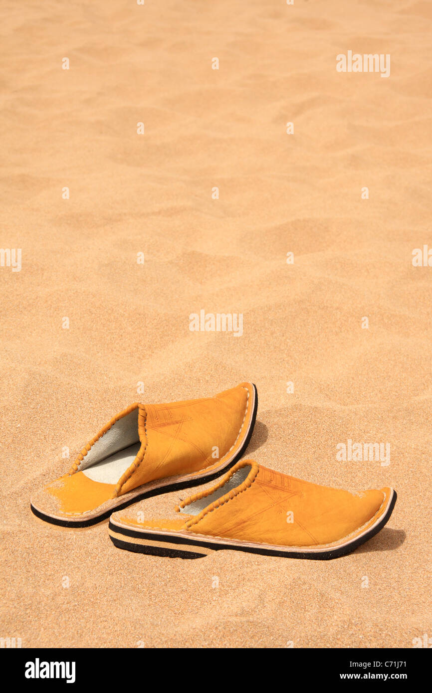 Marocchino tradizionale pantofola-scarpe (babouches) di sabbia su una spiaggia marocchino con copia spazio, Marocco, Africa del Nord Foto Stock