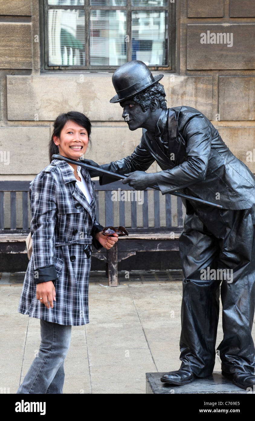 Chaplinesque street performer che interagisce con gli stati di pubblico Foto Stock