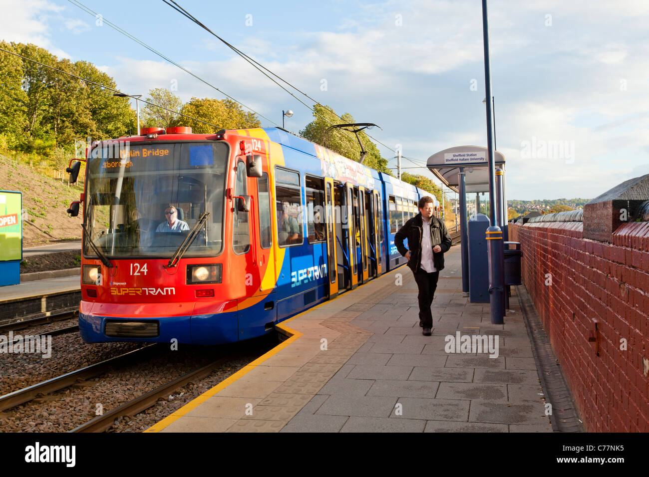Uomo di lasciare il supertram di Sheffield, tram, Sheffield vicina fermata del tram, Sheffield, Yorkshire, Inghilterra, Regno Unito Foto Stock