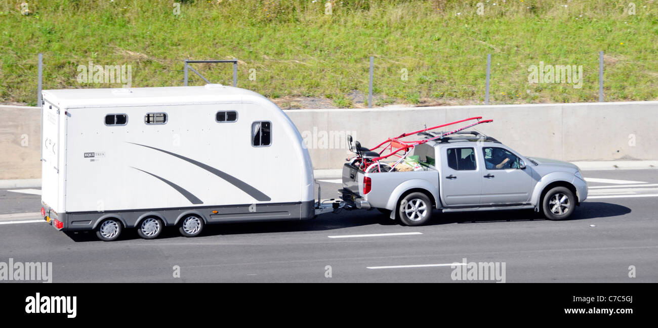 Equi Trek cavallo rimorchio trainato da pickup truck lungo l'autostrada M25, Essex England Regno Unito Foto Stock