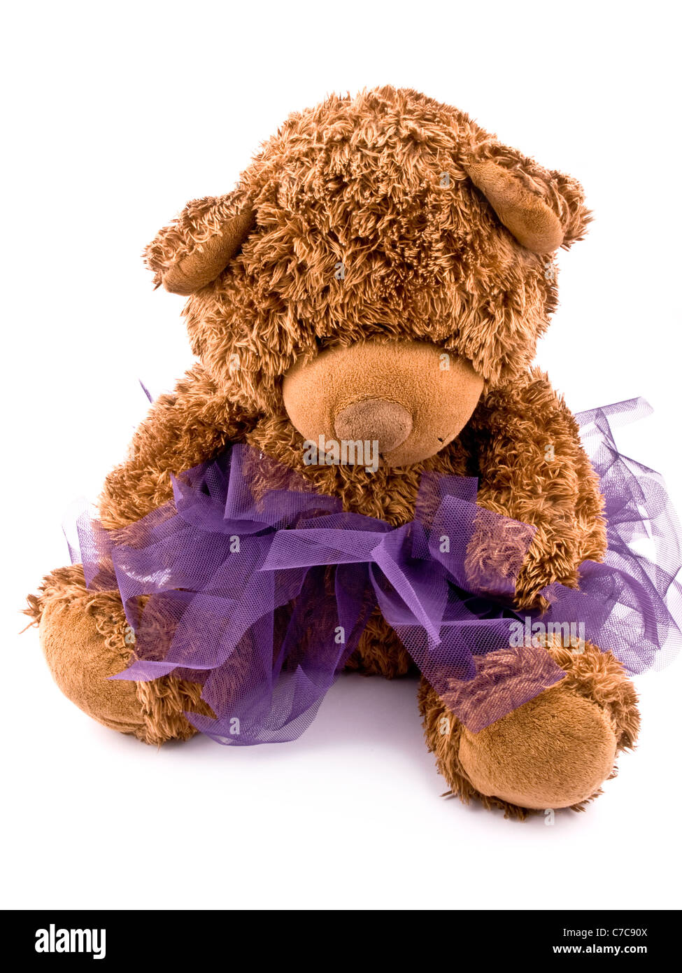 Big teddy-bear in viola gonna tutu su sfondo bianco Foto Stock