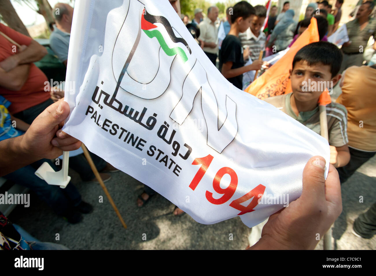 I manifestanti portano i banner di sostenere la costituzione dello Stato palestinese durante una manifestazione di protesta in Al-Walaja, West Bank. Foto Stock