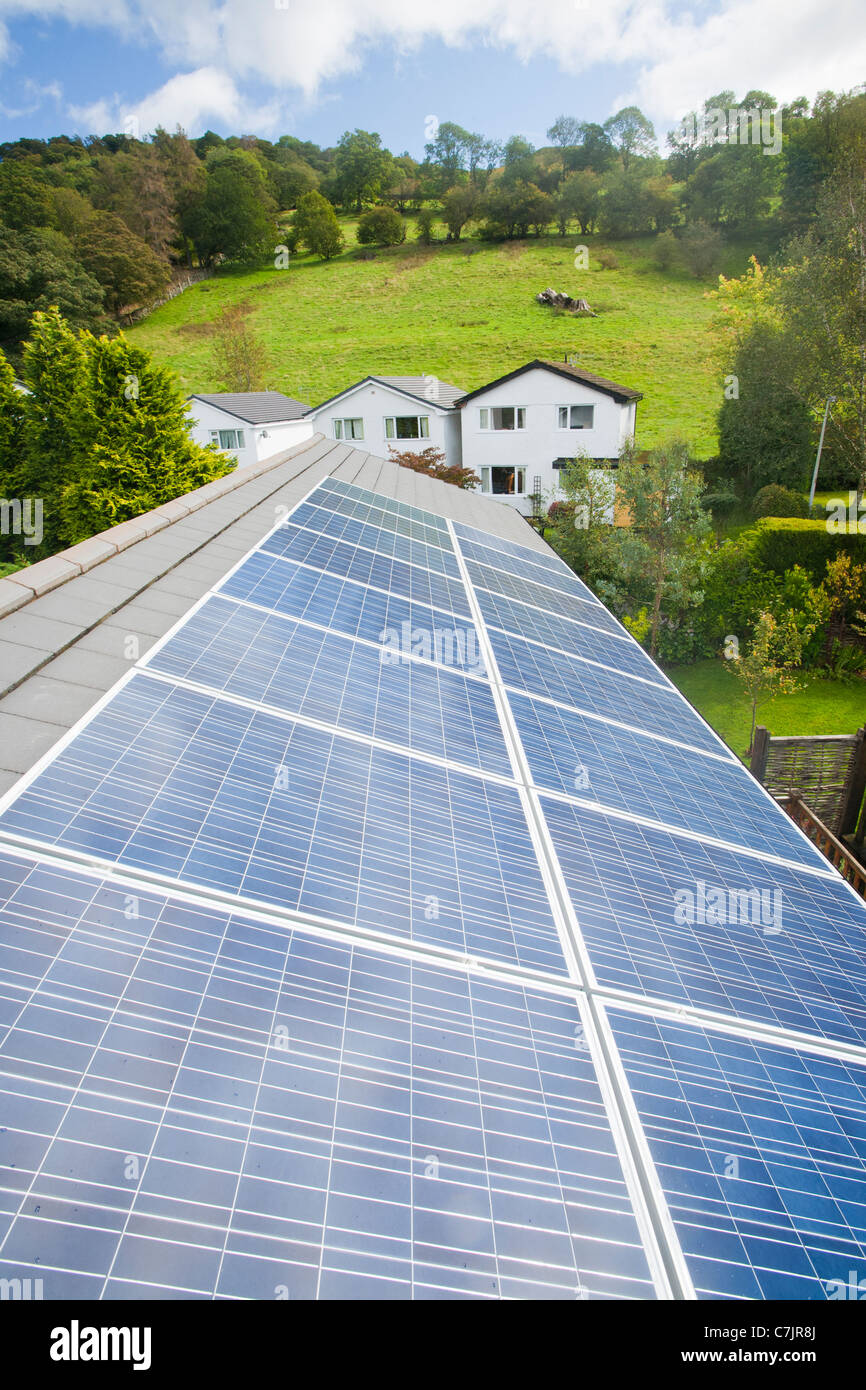Energia solare fotovoltaica in pannelli su un tetto di casa a Ambleside, Cumbria, Regno Unito. Foto Stock