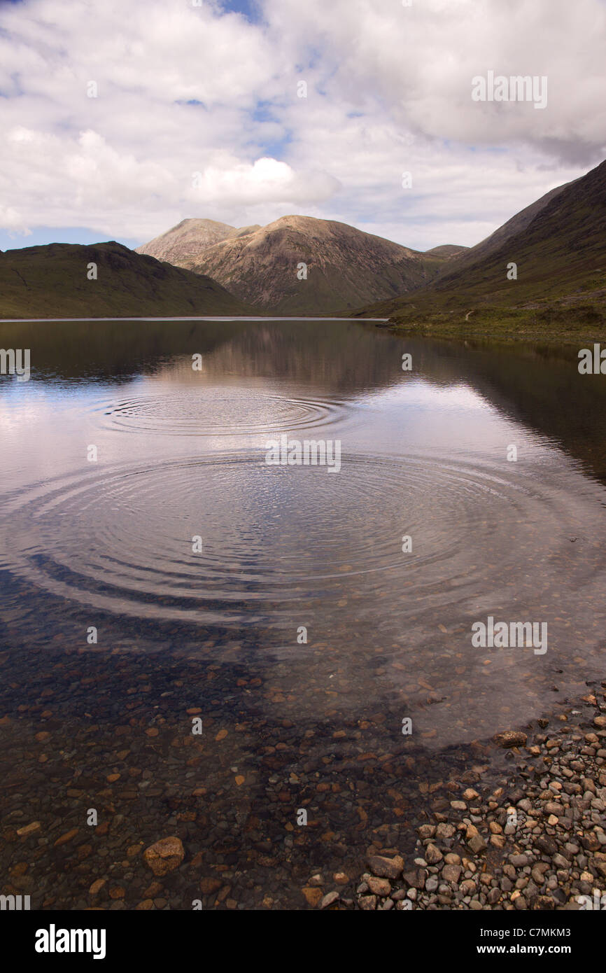 Increspature su acque ancora di Loch na Creitheach con Red Cuillin montagne in distanza, Camasunary, Isola di Skye, Scotland, Regno Unito Foto Stock