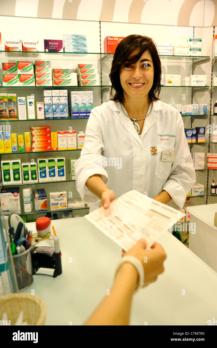 Il farmacista in piedi in farmacia (dare la prescrizione) Foto Stock
