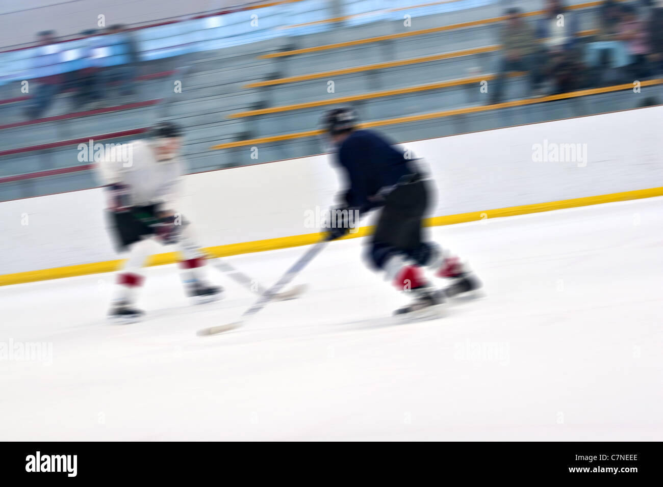 Abstract motion blur di due giocatori di hockey pattinaggio giù per la pista di pattinaggio su ghiaccio. Foto Stock