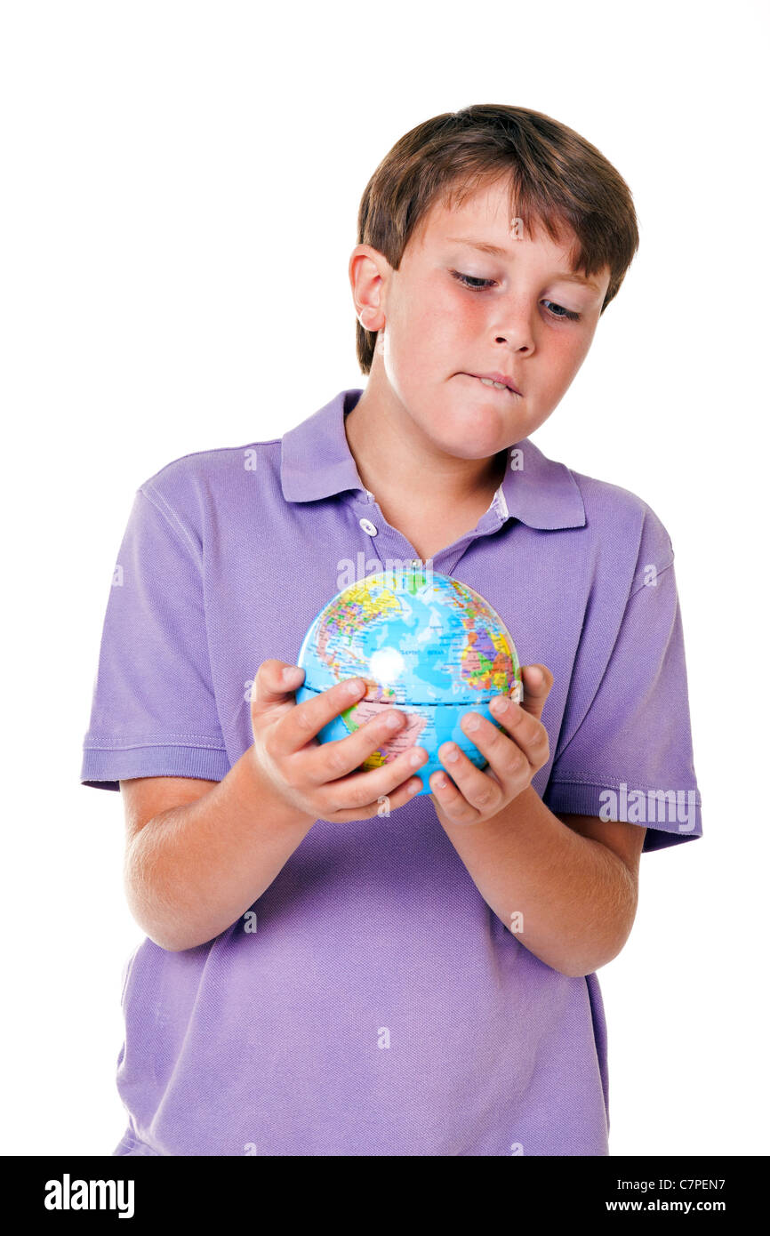 Foto di un 11 anno vecchio ragazzo scuola tenendo un globo mondo, isolata su uno sfondo bianco. Foto Stock