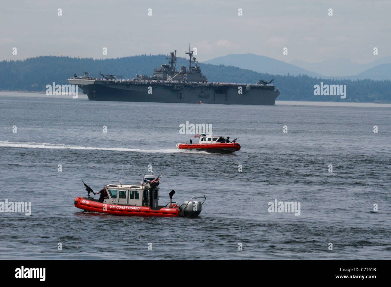 US Coast Guard motovedette che fissano il modo per l assalto anfibio nave USS Bonhomme Richard LHD-6 per dock di Seattle Foto Stock