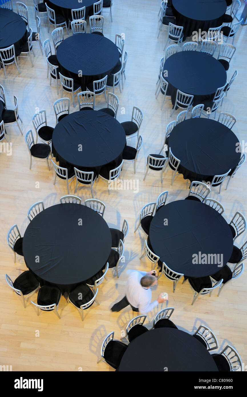 Vista aerea di un ristorante con tabelle vuote. Un cameriere passa, motion blur sull'uomo. Foto Stock