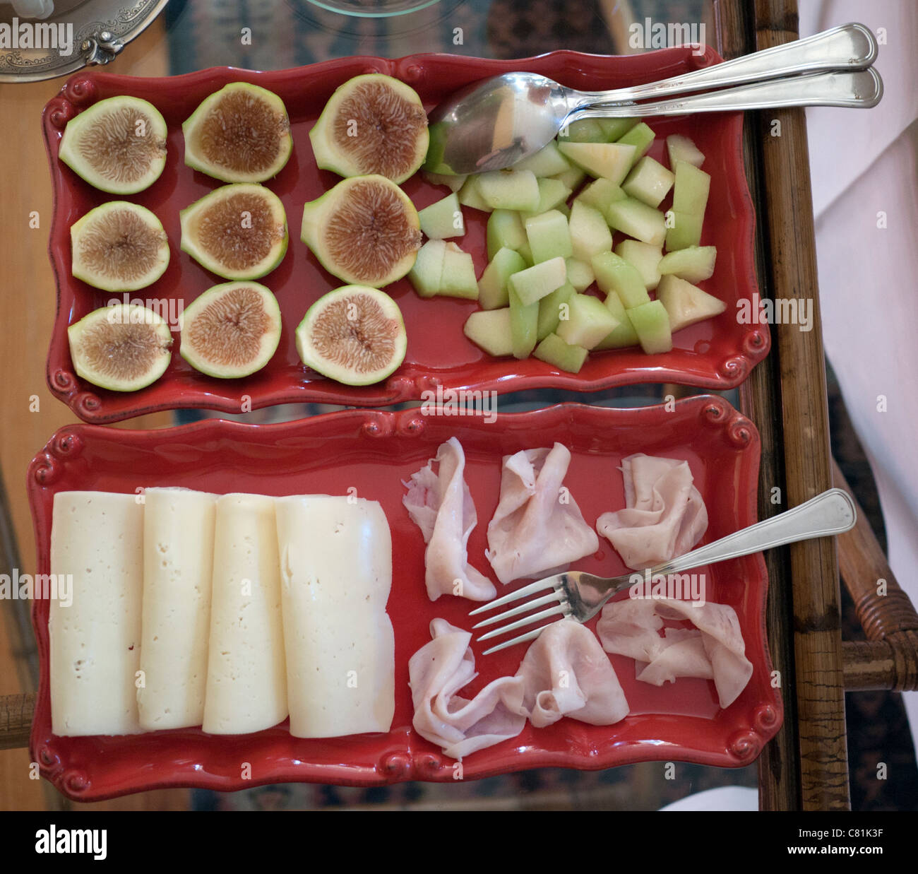 Una "colazione continentale" a Solares B&B in Portogallo e ne ha ottenuto ; le figg, melone, formaggio e prosciutto, tutti serviti in rosso i vassoi in ceramica. Foto Stock