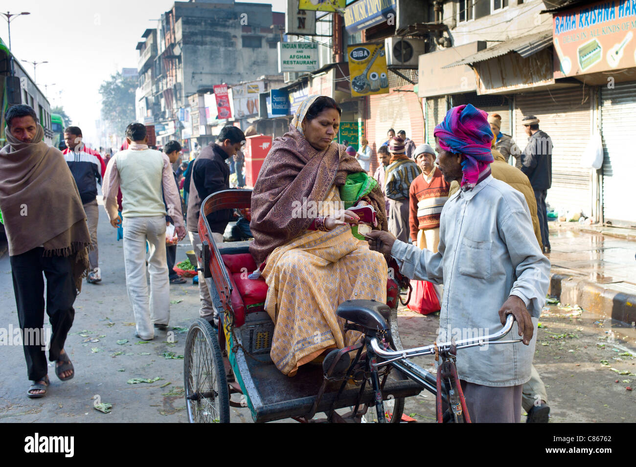 Donna indiana shopping in rickshaw nella Vecchia Delhi a Daryagang mercato di frutta e verdura, India Foto Stock