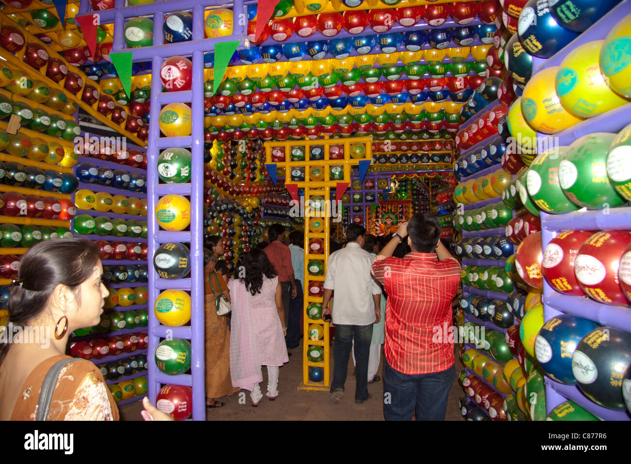 I devoti a 'Karbagan Durga Puja pandal' fatta di plastica colorata di palline in 'Ultadanga', Kolkata (Calcutta), West Bengal, India. Foto Stock
