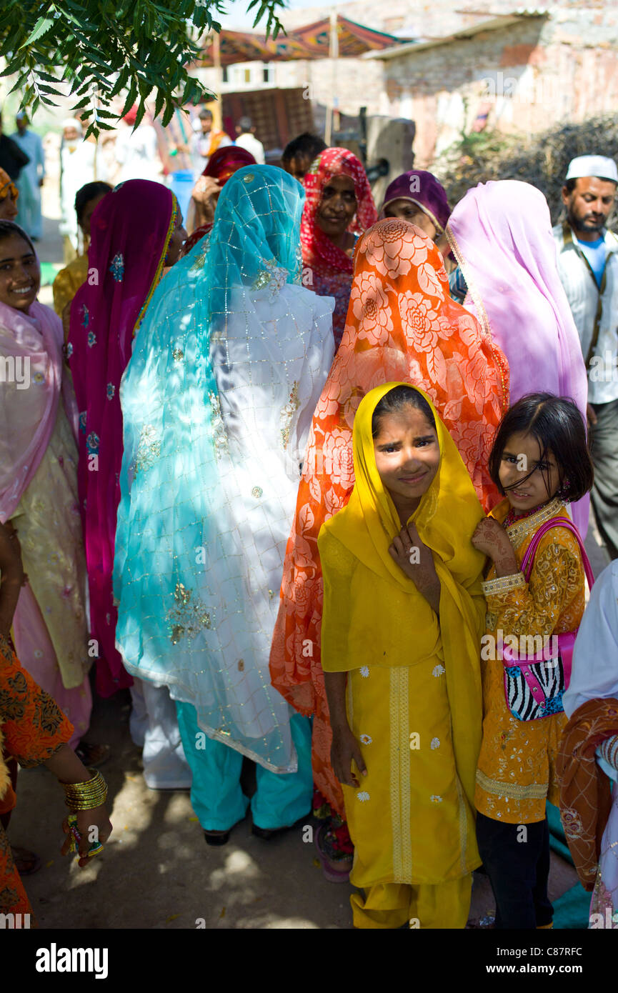 Indian nozze con gli ospiti vestiti nei loro migliori abbellito sari nel villaggio di Rohet nel Rajasthan, India settentrionale Foto Stock