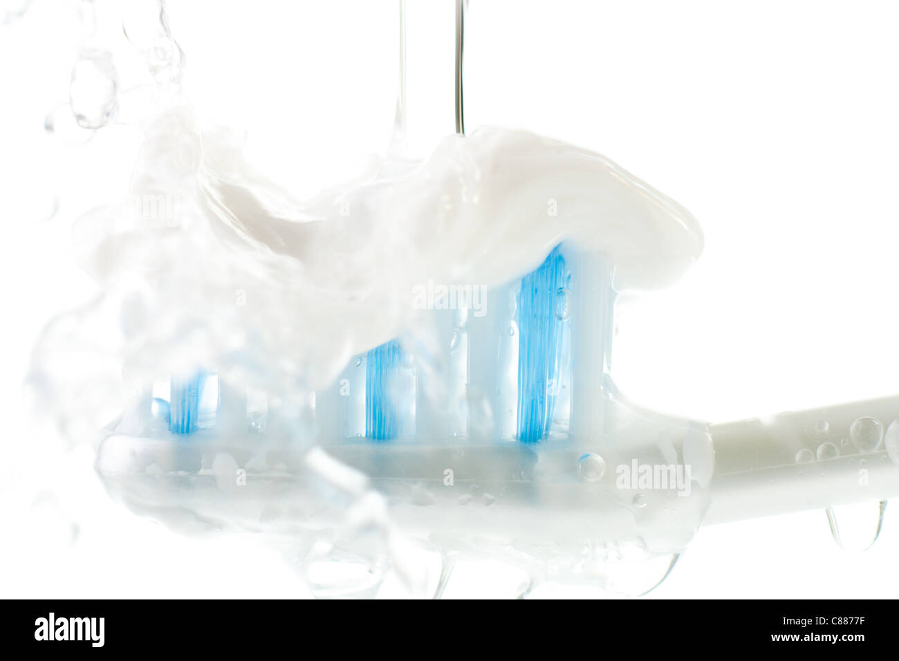 Wet spazzolino da denti con dentifricio isolato su bianco Foto Stock