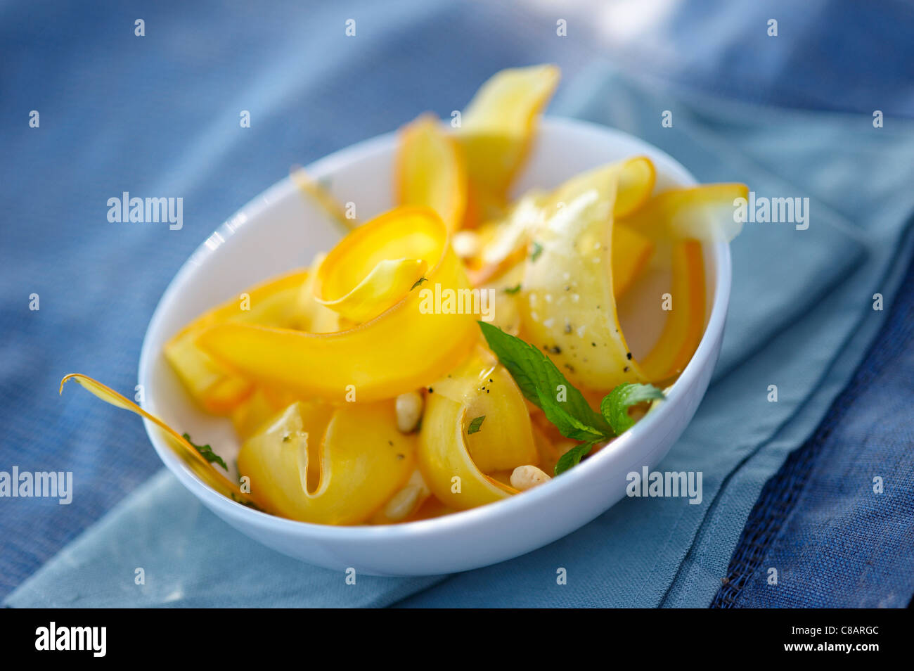 Tagliate a fettine sottili giallo zucchine con pinoli e menta fresca Foto Stock