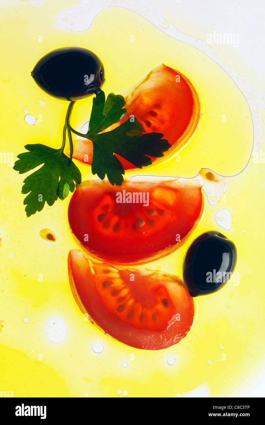 Pomodoro a fette, olive nere e prezzemolo in olio Foto Stock