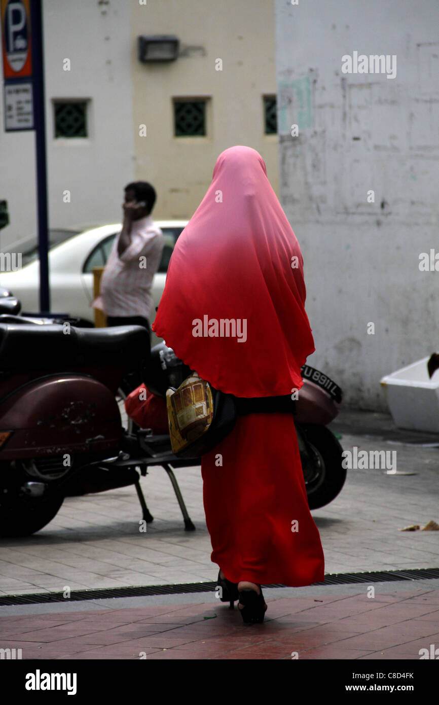 Woman in Red sari camminando lungo la strada di Buffalo, Little India, Singapore Foto Stock