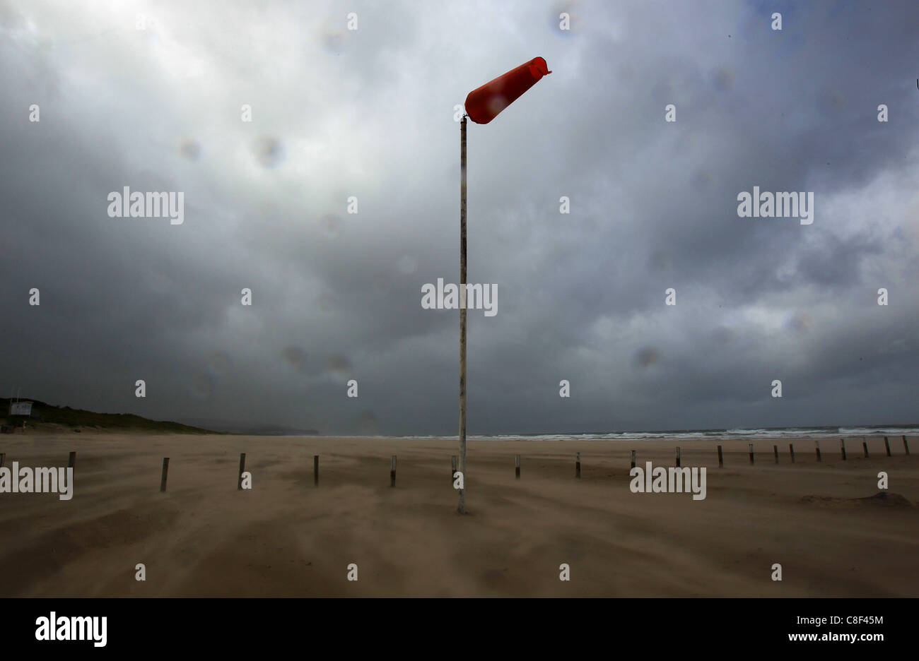 Una calza di vento e la sabbia soffiare lungo Portstewart Strand spiaggia in Portstewart, Irlanda del Nord Foto Stock