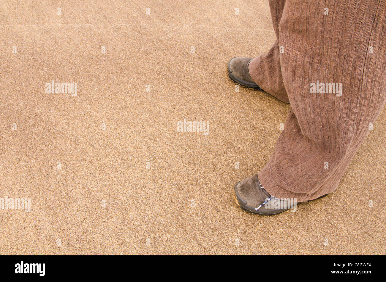 Coppia di piedi in scarpe sulla sabbia Foto Stock