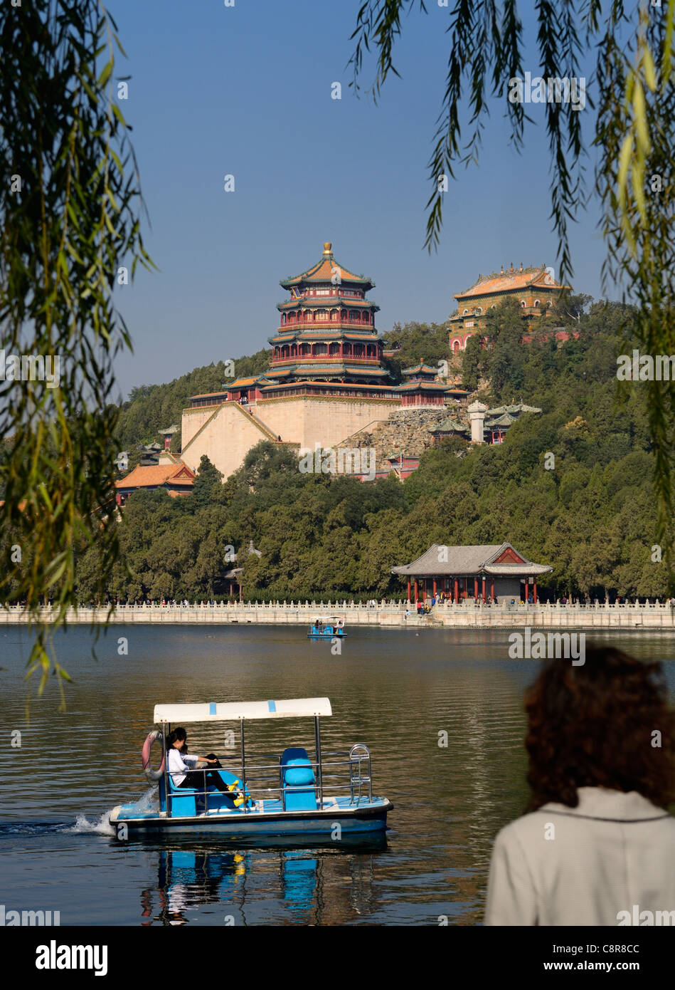 Tourist guardando la racchetta diportisti sul Lago Kunming buddista di Tempio di fragranza al Palazzo Estivo Pechino Repubblica Popolare Cinese Foto Stock